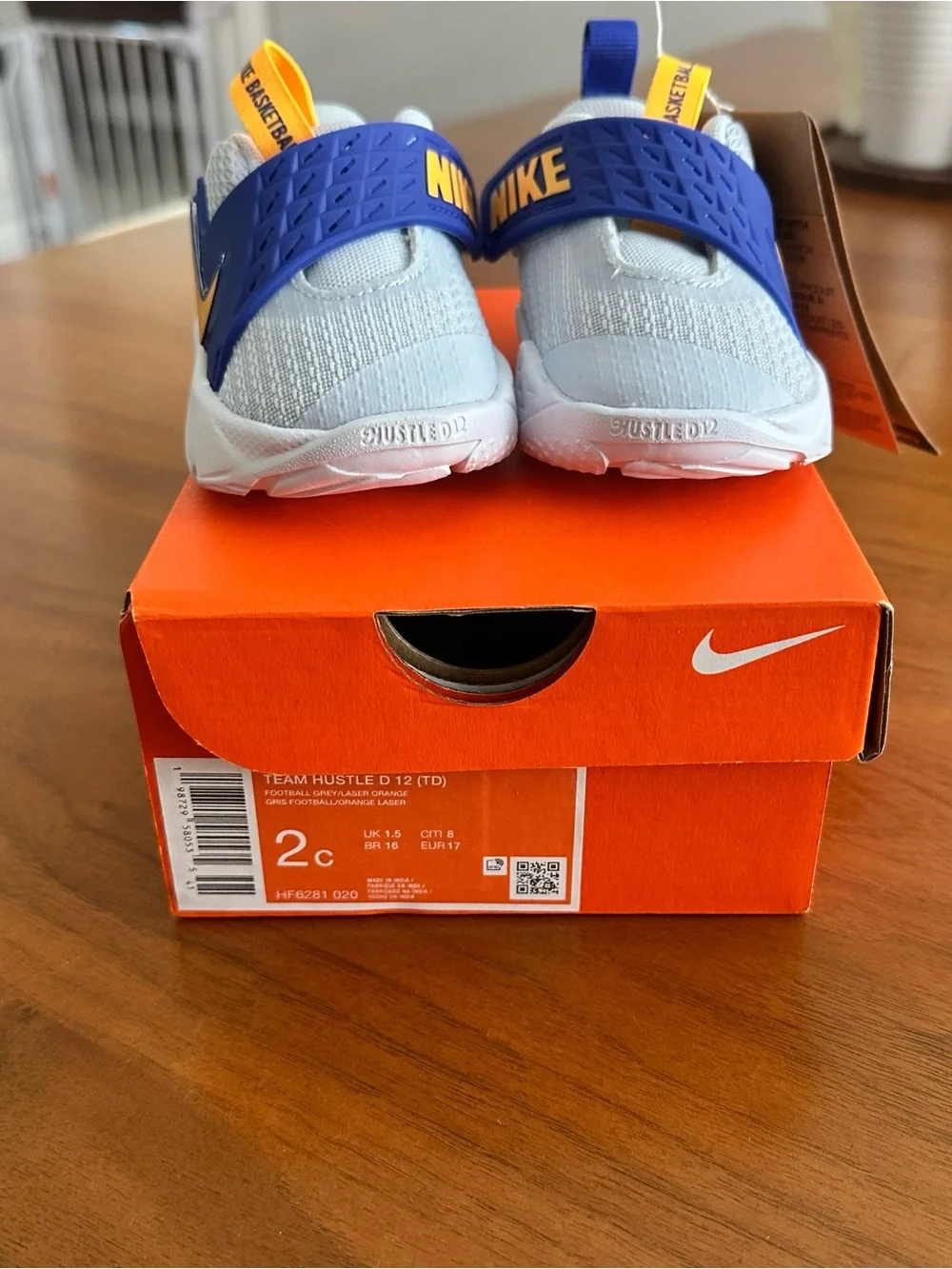 Nike Kids White Sneakers with Blue and Yellow Accents - Team Hustle